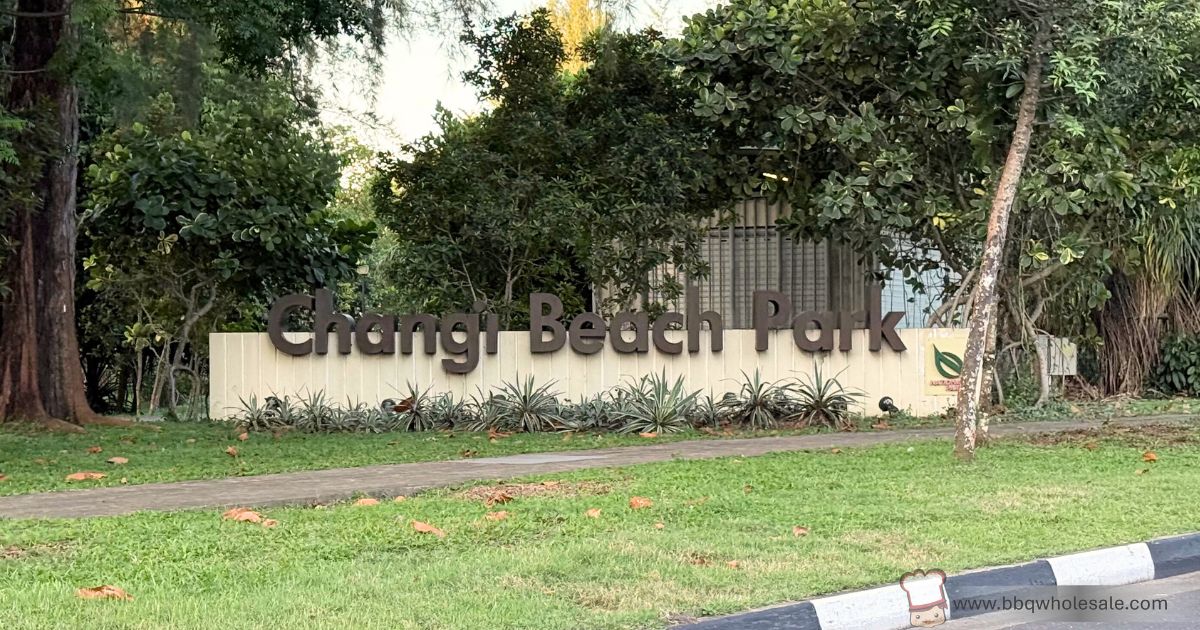 Changi Beach Park entrance sign with NParks logo, Singapore coastal park where BBQ pits are available for booking